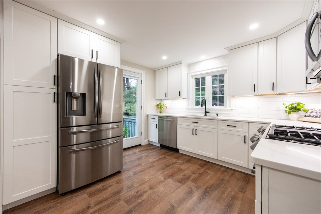 841 Lincoln Street Franklin, MA 02038 - Photo 6 of 25 a kitchen with a refrigerator a sink cabinets and wooden floor