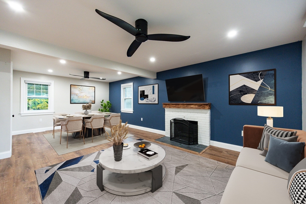 841 Lincoln Street Franklin, MA 02038 - Photo 7 of 25 a living room with furniture a fireplace and a flat screen tv