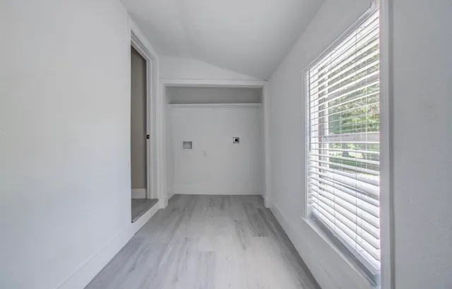 a view of a room with wooden floor and windows