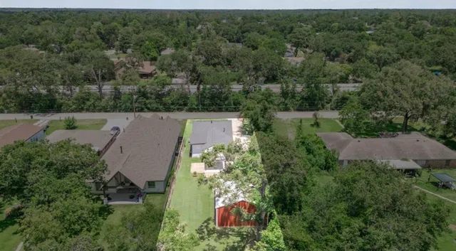 an aerial view of a house with a yard