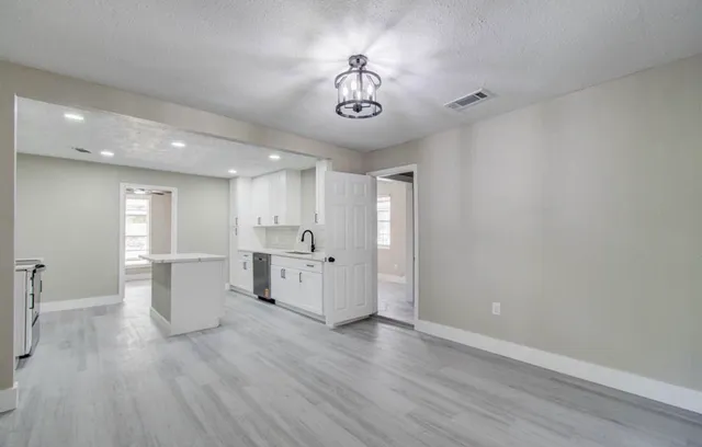 a view of a kitchen with stove and wooden floor