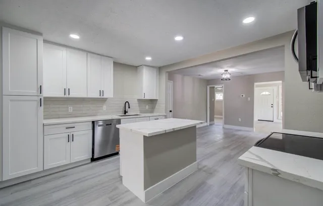 a kitchen with a sink stove and cabinets