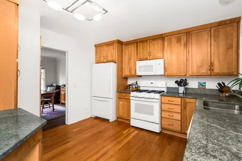 a kitchen with a refrigerator stove top oven and sink