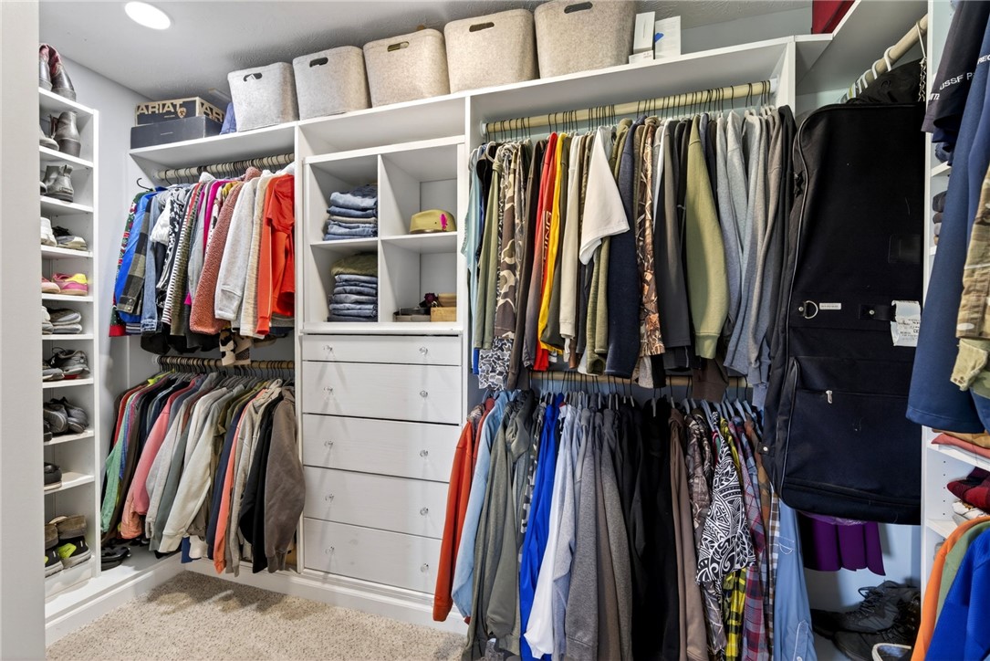 39 Holly Court Springboro, OH 45066 - Photo 19 of 42 This spacious closet features ample storage solutions for an organized and functional dressing area.