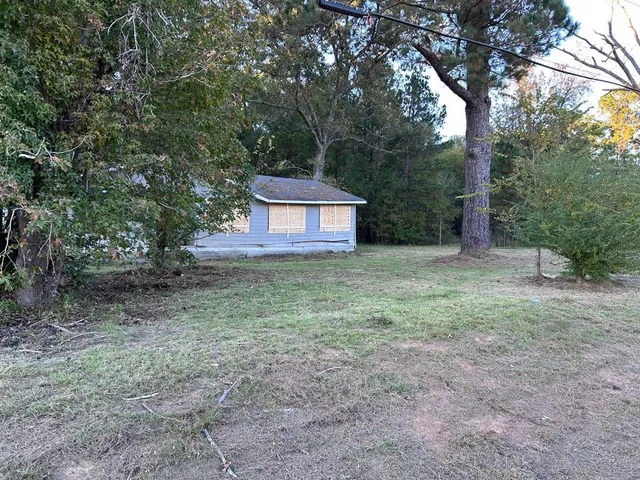 a view of a house with yard and a tree