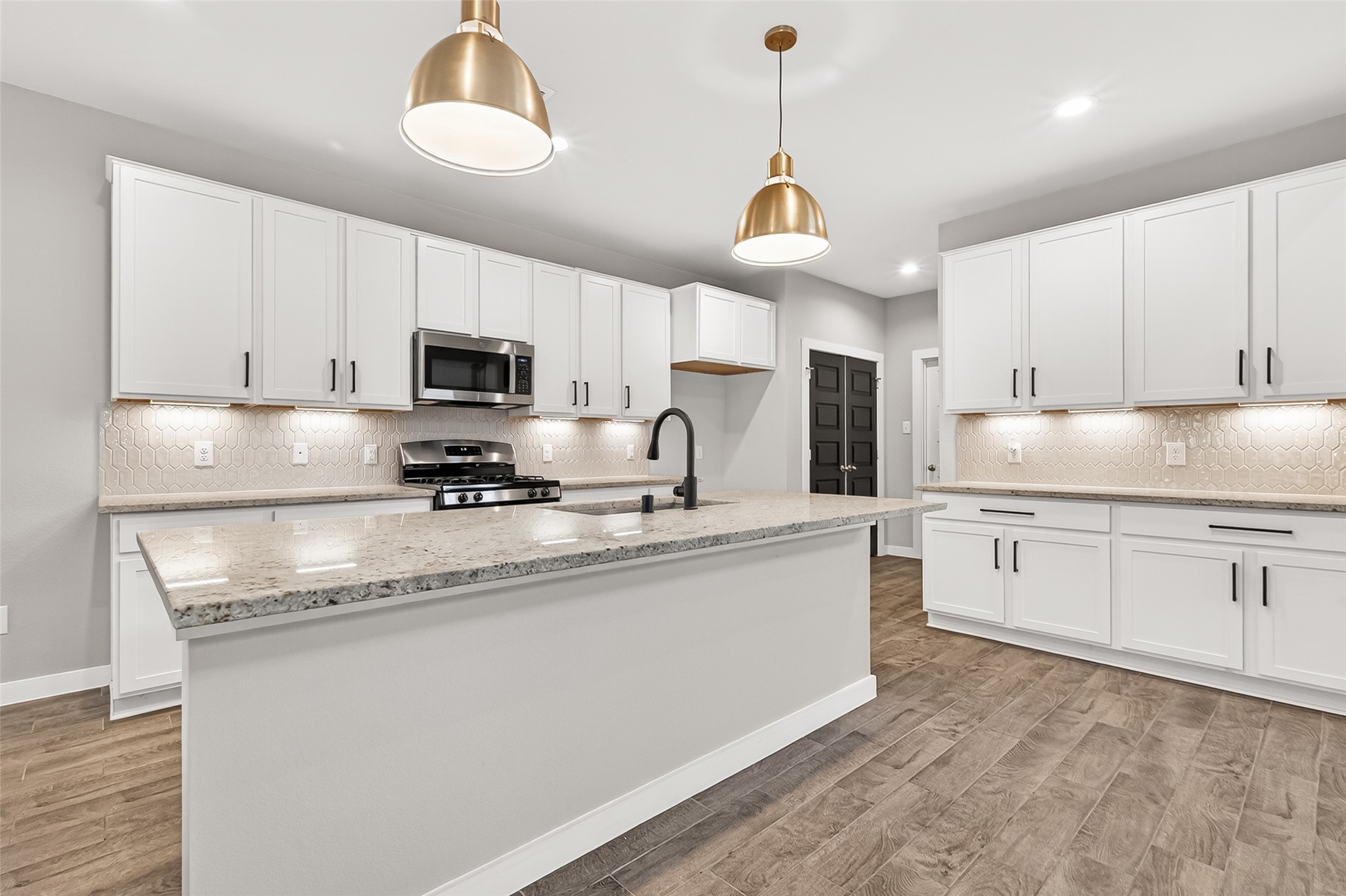 2142 Reed Cave Lane Spring, TX 77386 - Photo 19 of 50 a kitchen with granite countertop a sink stainless steel appliances and white cabinets
