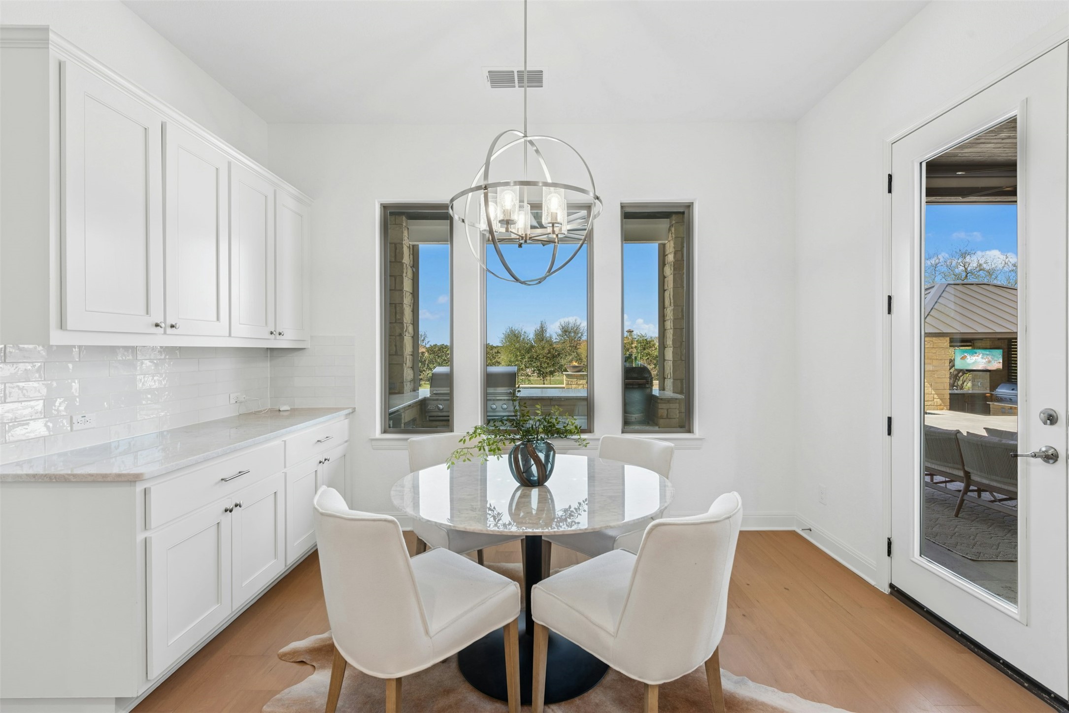 401 Brave Face Street Leander, TX 78641 - Photo 12 of 35 Dining space featuring light wood-style floors and hanging lights