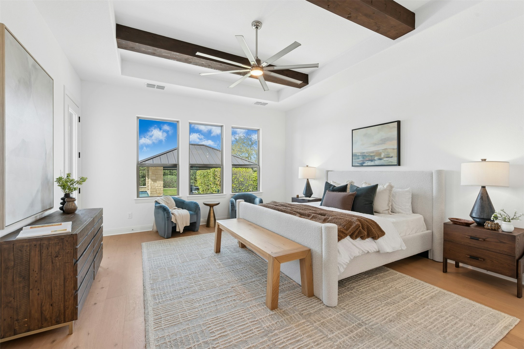 401 Brave Face Street Leander, TX 78641 - Photo 13 of 35 Bedroom featuring a tray ceiling, light wood finished floors, ceiling fan, and beam ceiling