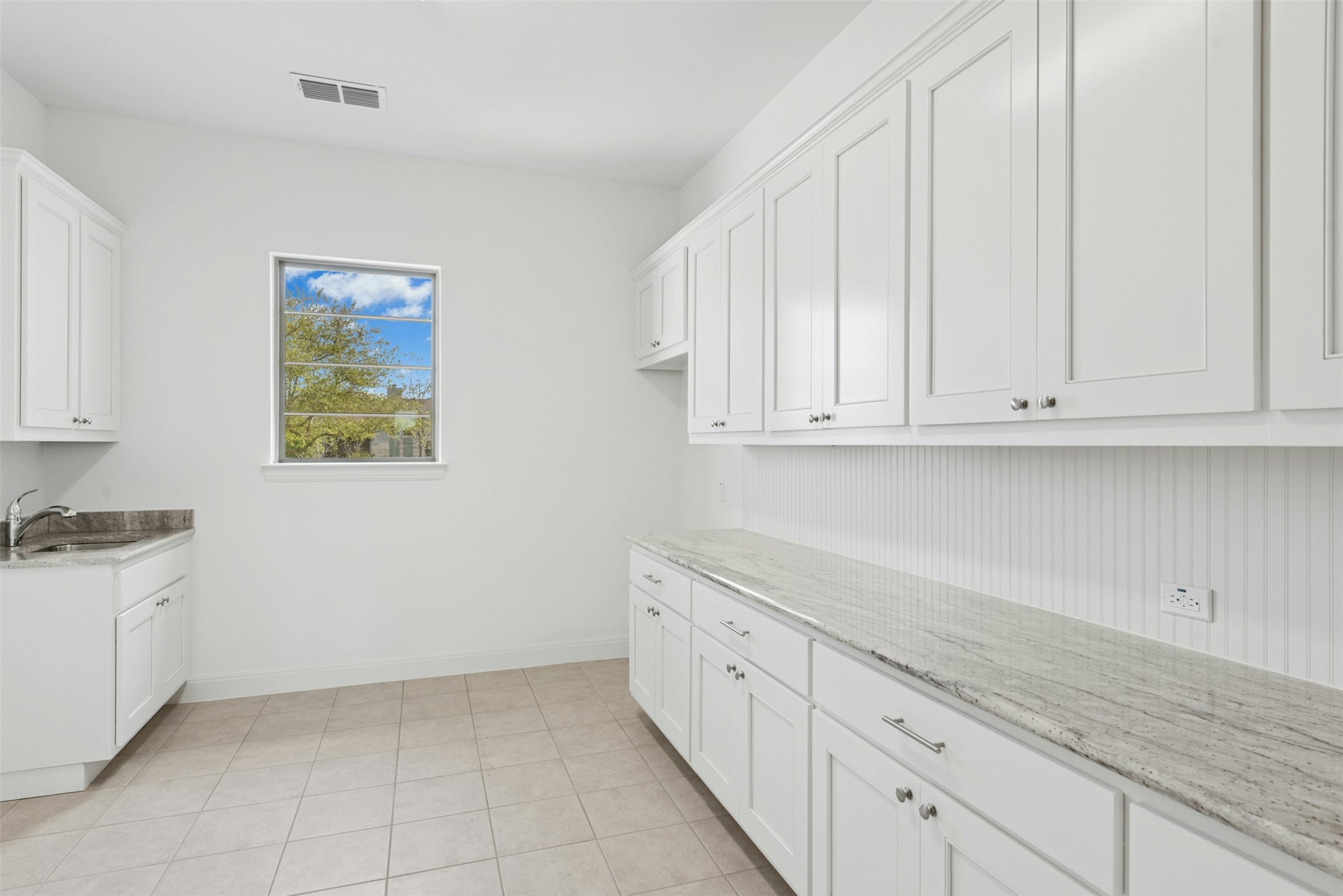 401 Brave Face Street Leander, TX 78641 - Photo 19 of 35 Laundry room featuring large cabinets, utility sink, and large countertops