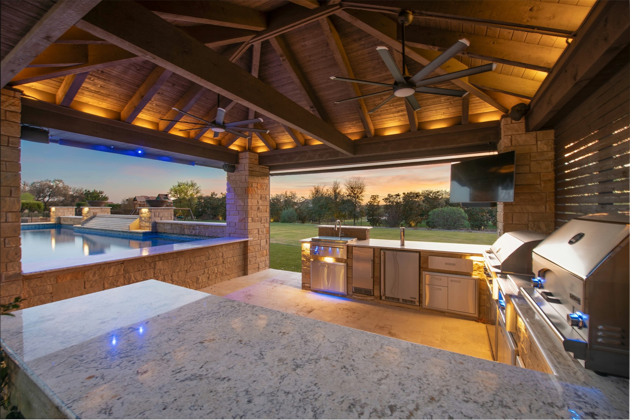 401 Brave Face Street Leander, TX 78641 - Photo 3 of 35 View of patio / terrace featuring exterior kitchen, ceiling fan, and an outdoor pool