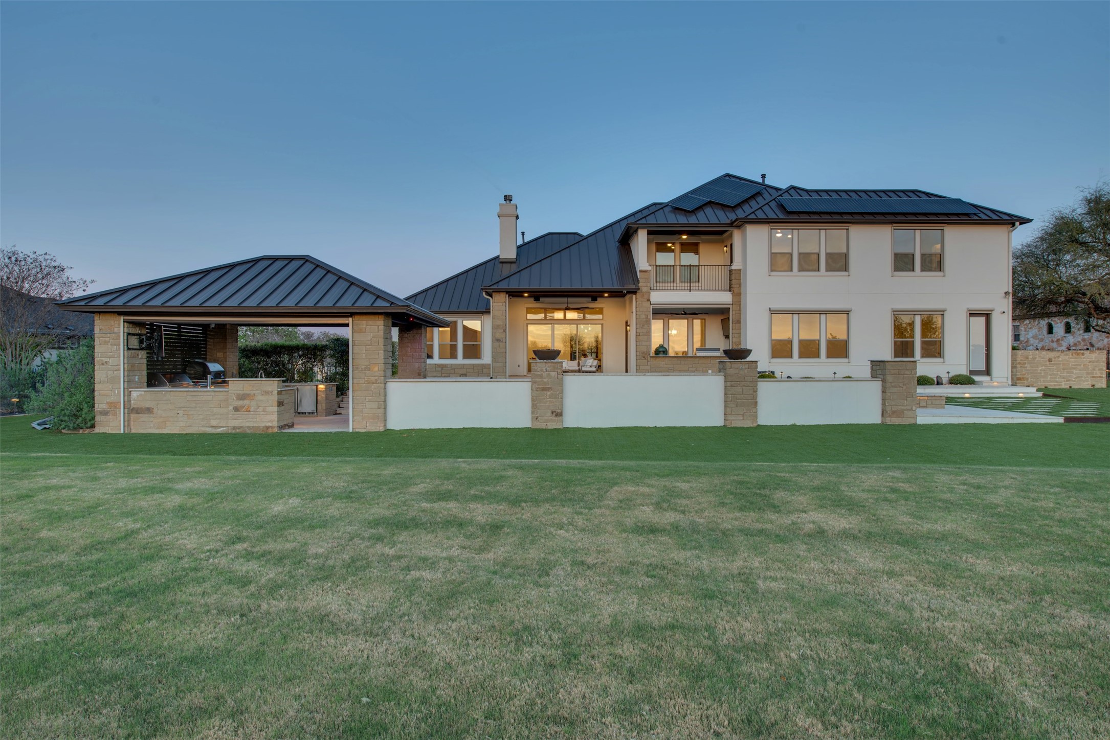 401 Brave Face Street Leander, TX 78641 - Photo 33 of 35 Rear view of house with an outdoor kitchen, a standing seam roof, a patio, a yard, and a chimney