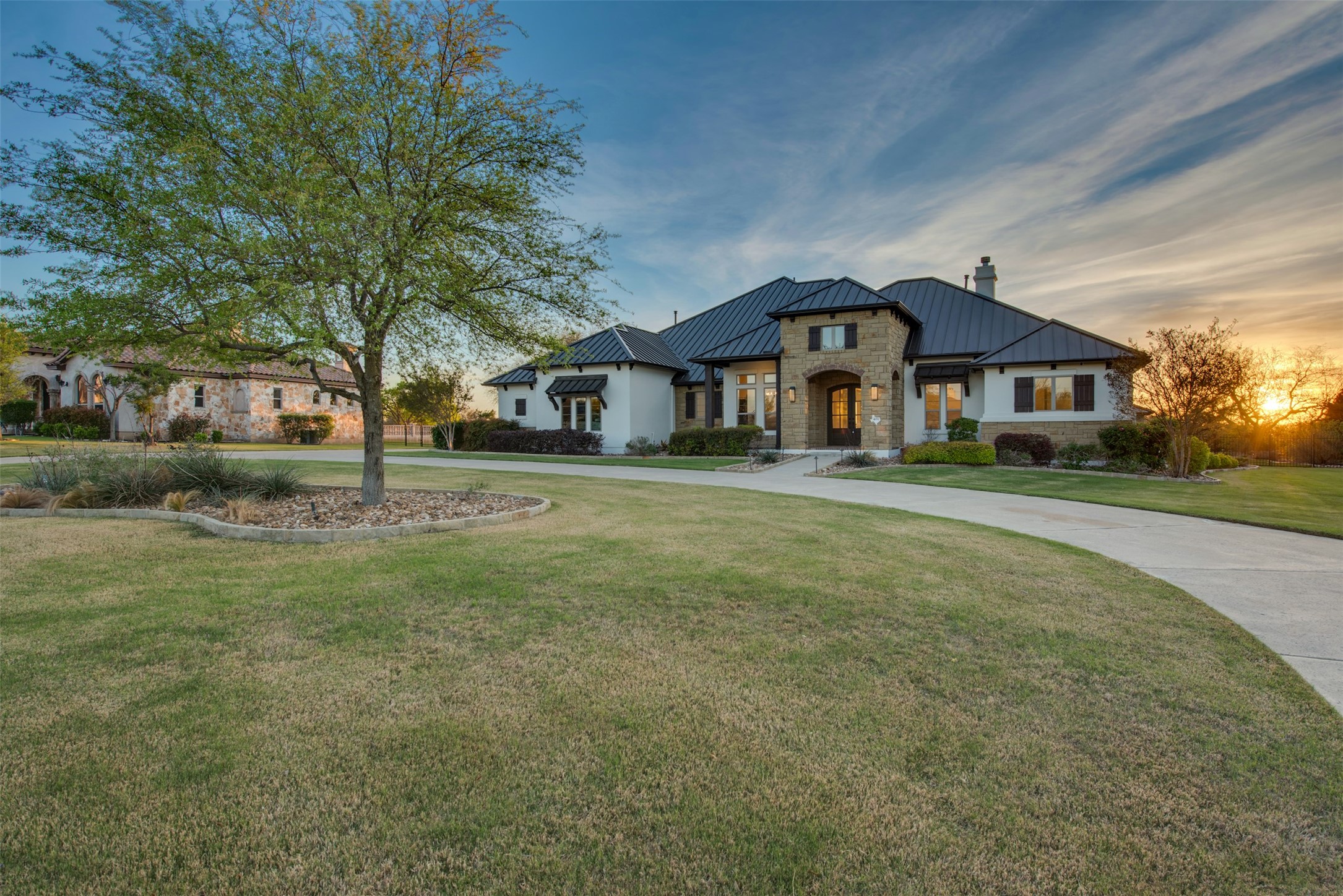 401 Brave Face Street Leander, TX 78641 - Photo 34 of 35 View of front of property featuring a standing seam roof, a yard, a chimney, and stone siding