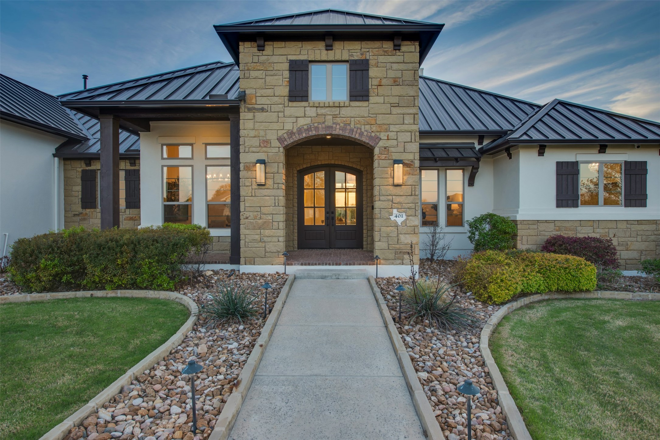 401 Brave Face Street Leander, TX 78641 - Photo 35 of 35 Entrance to property with a standing seam roof, stone siding, french doors, and a lawn