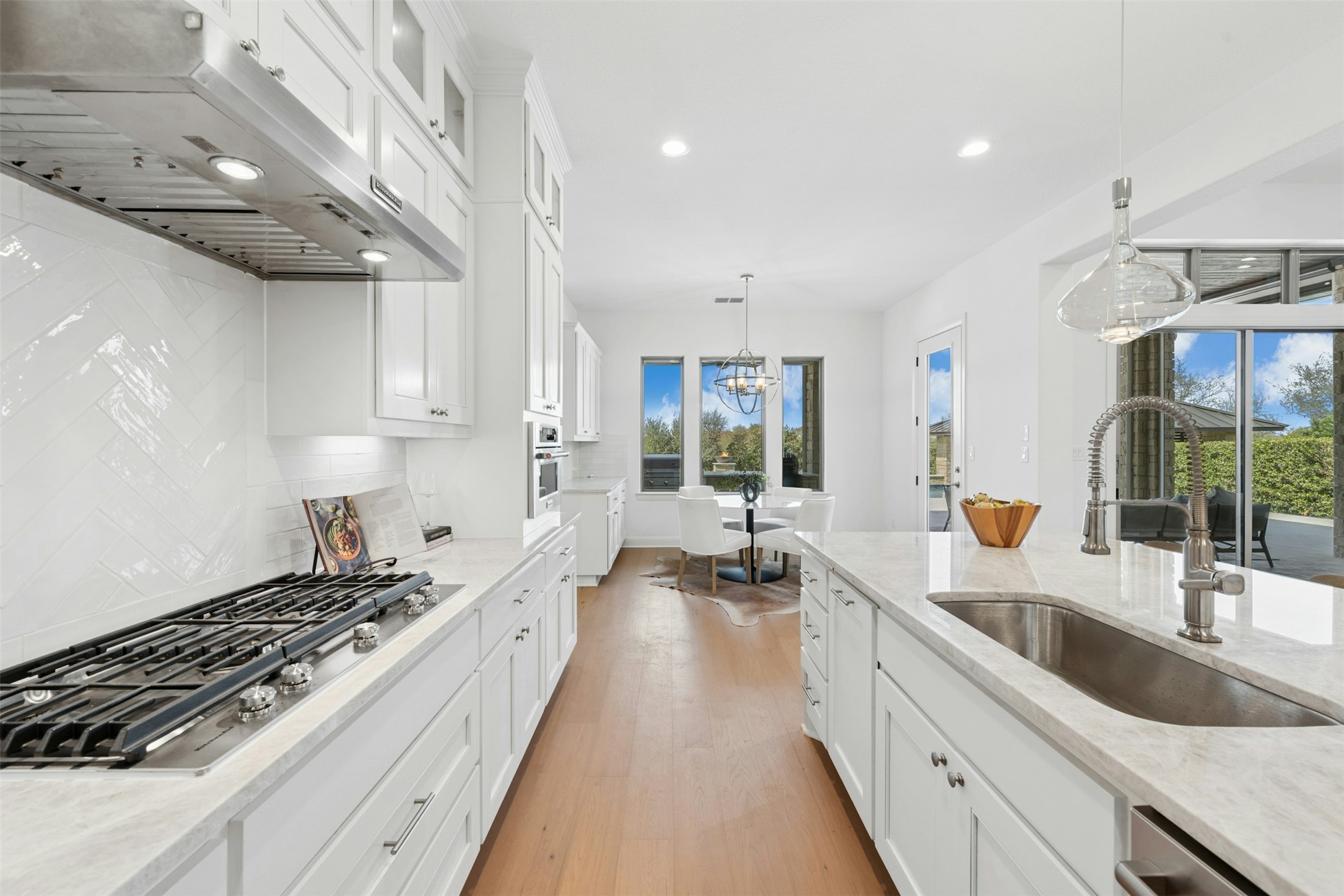 401 Brave Face Street Leander, TX 78641 - Photo 10 of 35 Kitchen with white cabinetry and light stone countertops