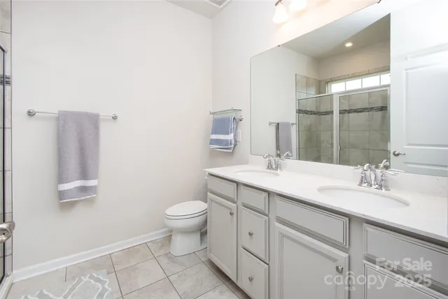 a bathroom with a sink toilet and mirror