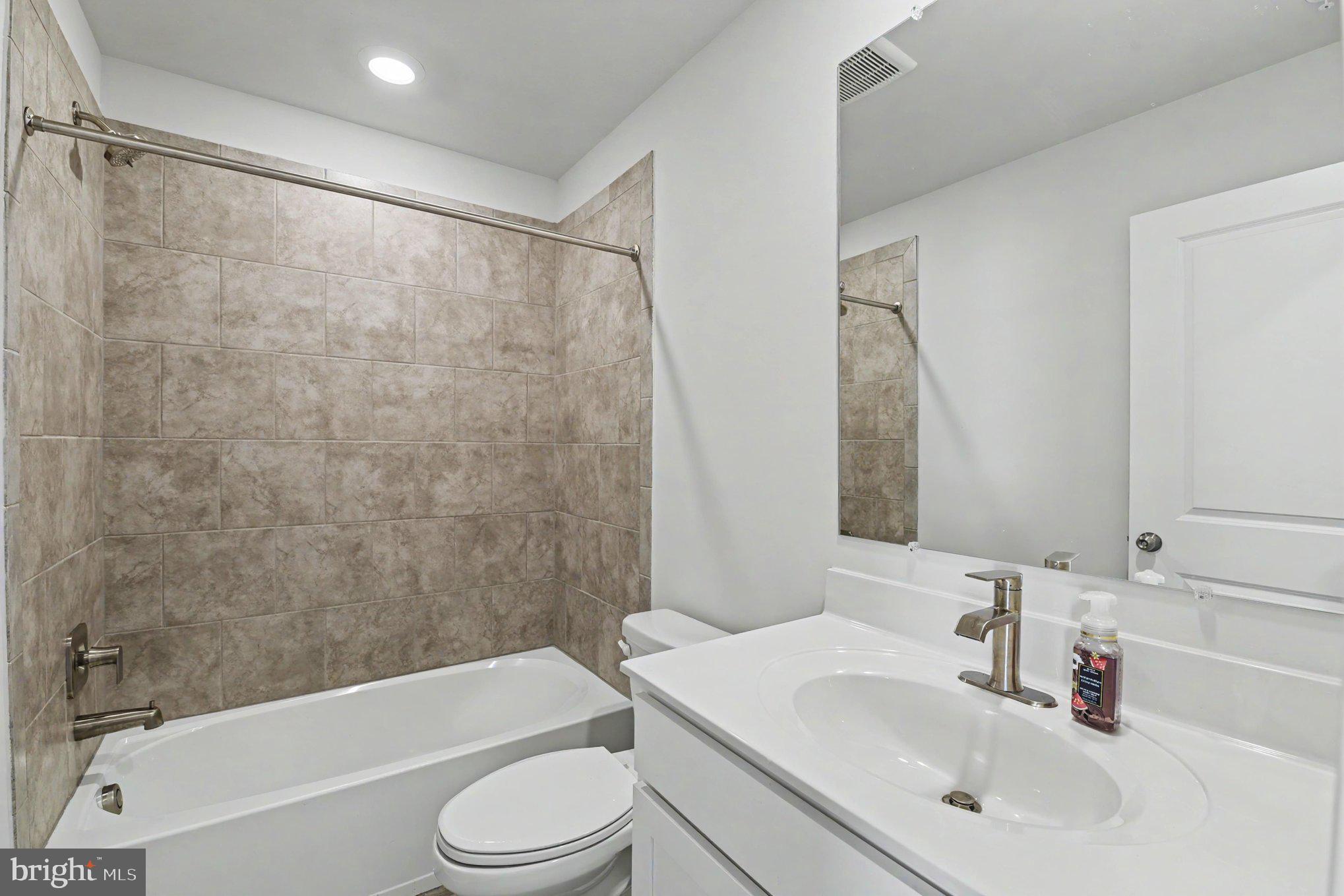 238 Waterstone Road Essex, MD 21221 - Photo 9 of 39 a bathroom with a sink toilet and shower