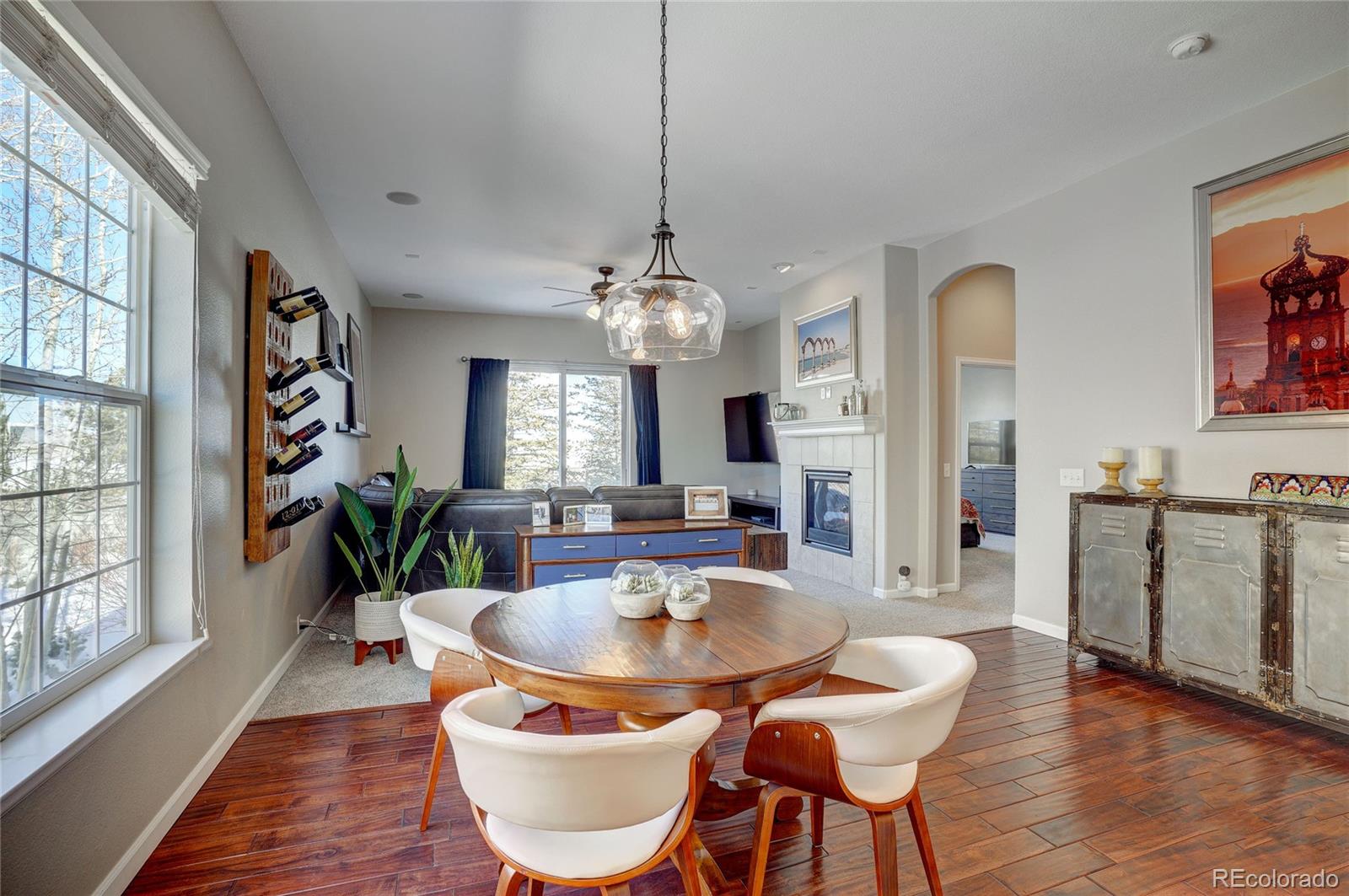 3563 Vestal Loop Broomfield, CO 80023 - Photo 12 of 38 a dining room with furniture a chandelier and wooden floor
