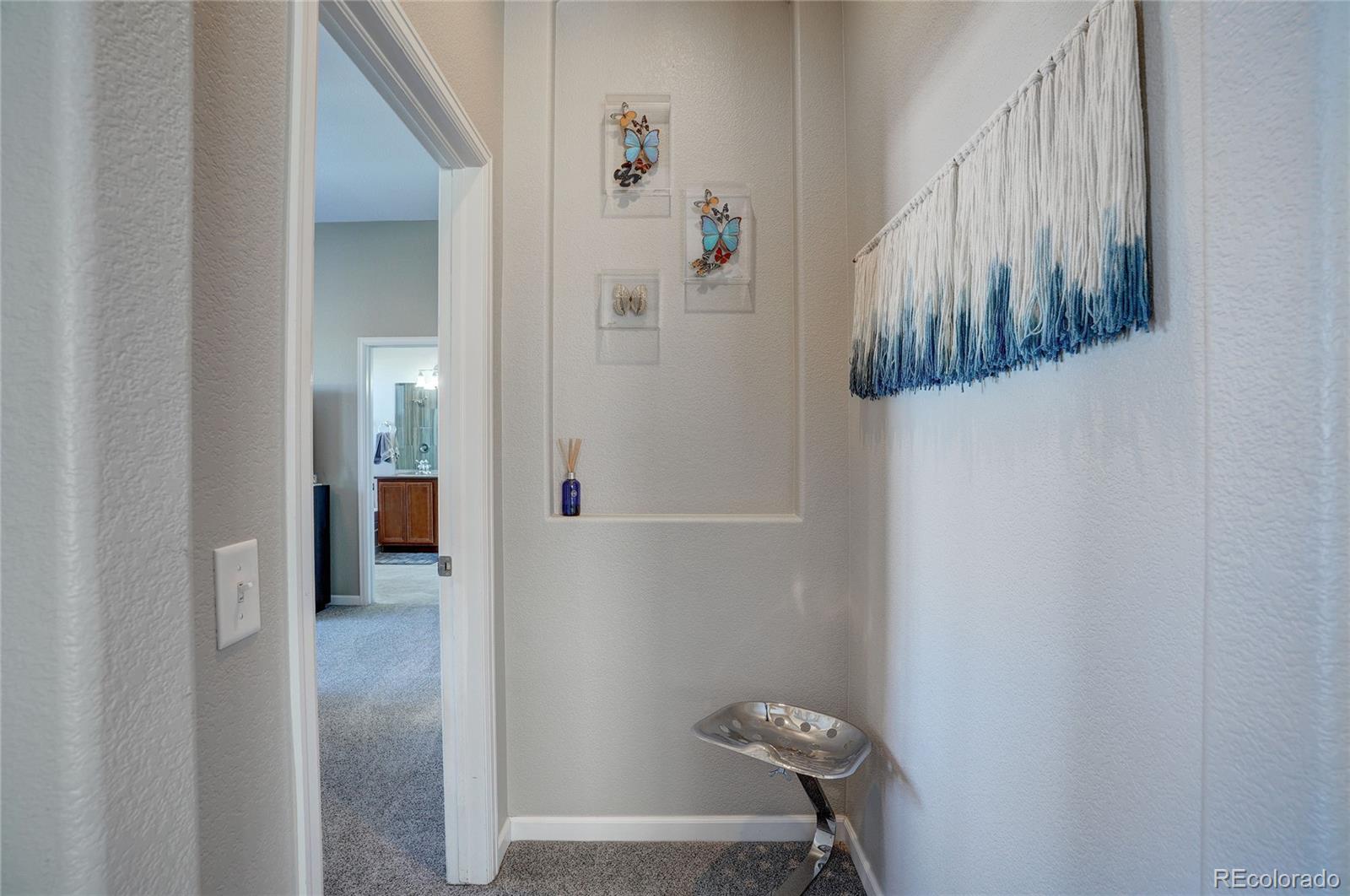 3563 Vestal Loop Broomfield, CO 80023 - Photo 16 of 38 a view of a hallway with paintings on the wall