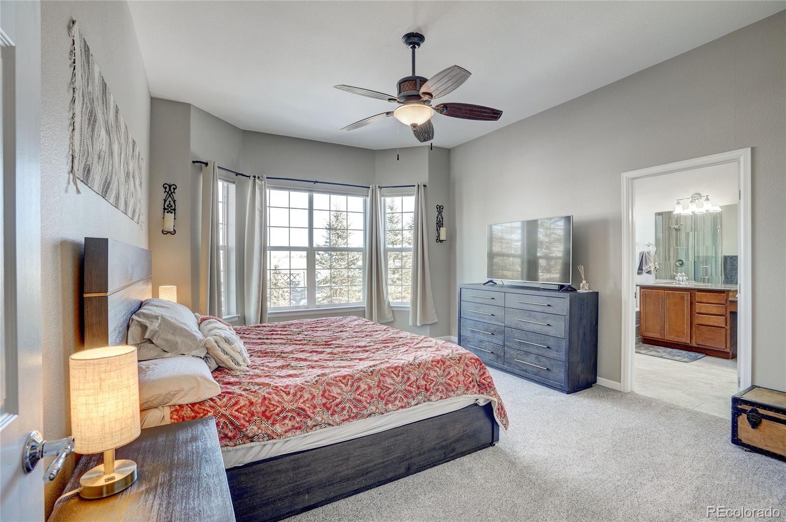 3563 Vestal Loop Broomfield, CO 80023 - Photo 17 of 38 a bedroom with a large bed and a chandelier