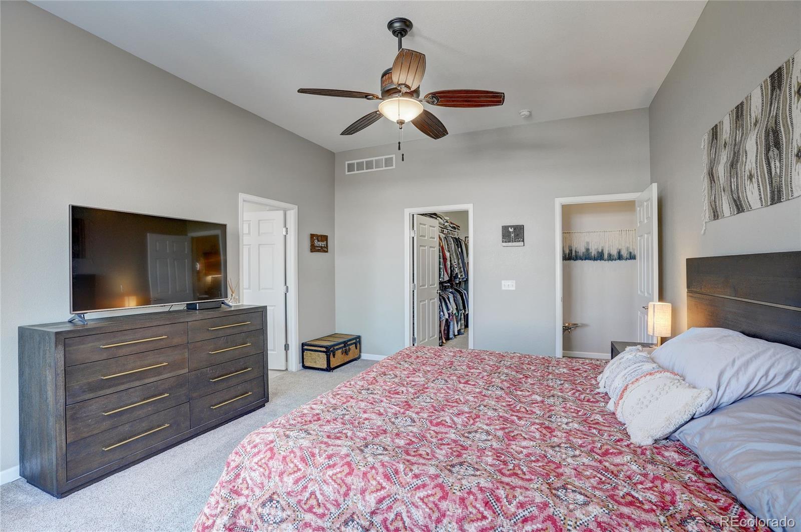 3563 Vestal Loop Broomfield, CO 80023 - Photo 18 of 38 a bedroom with a large bed and a flat tv screen on dresser