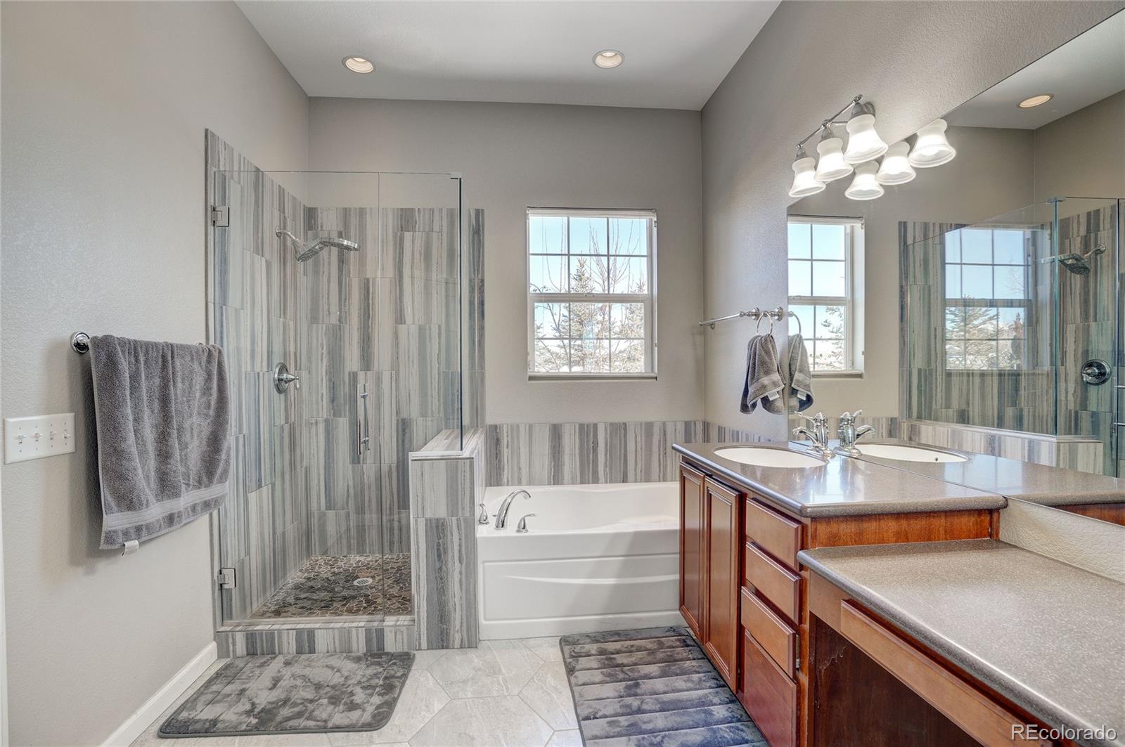 3563 Vestal Loop Broomfield, CO 80023 - Photo 19 of 38 a bathroom with double vanity and a mirror