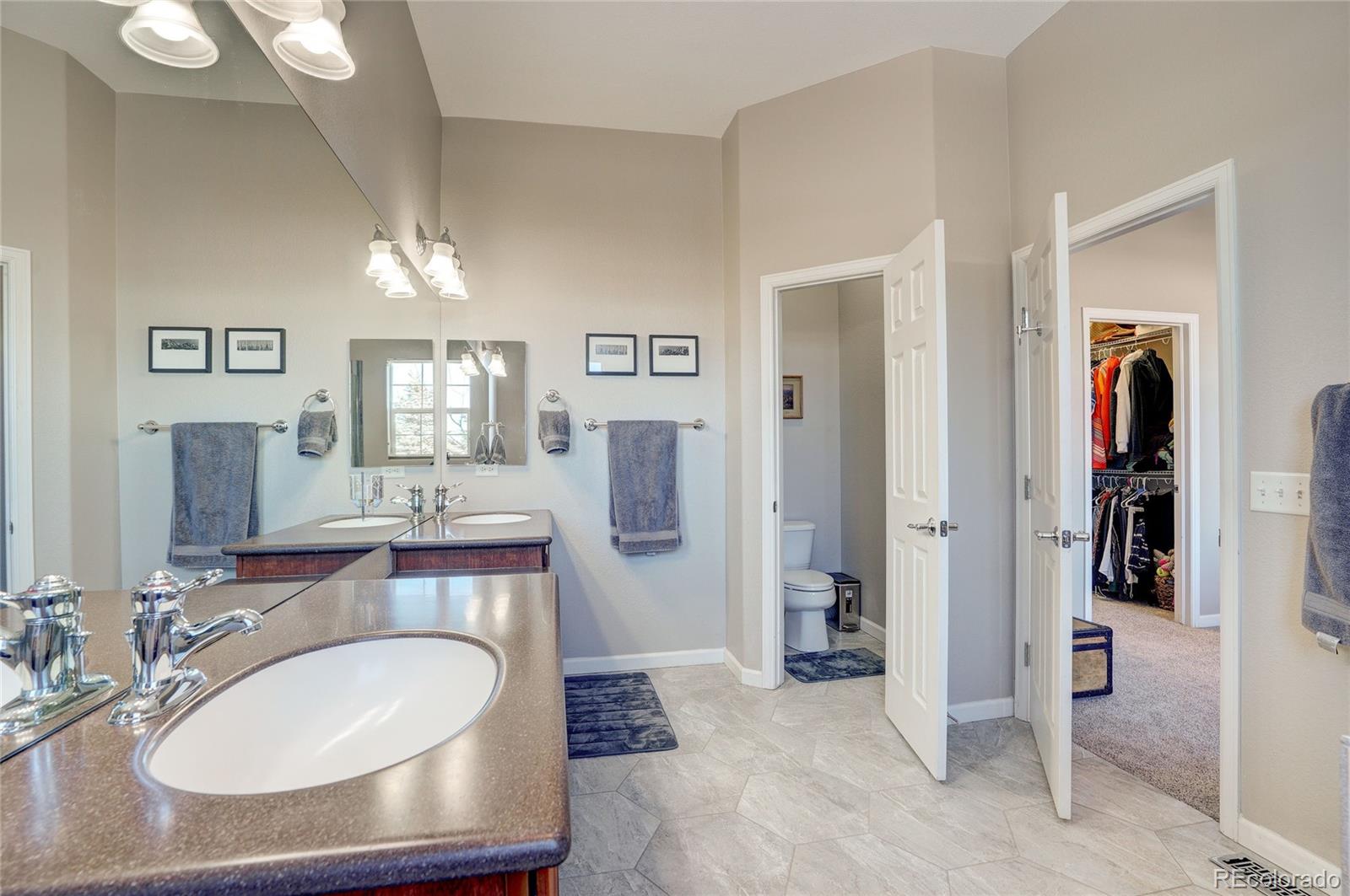 3563 Vestal Loop Broomfield, CO 80023 - Photo 20 of 38 a en suite bathroom with a sink and a mirror