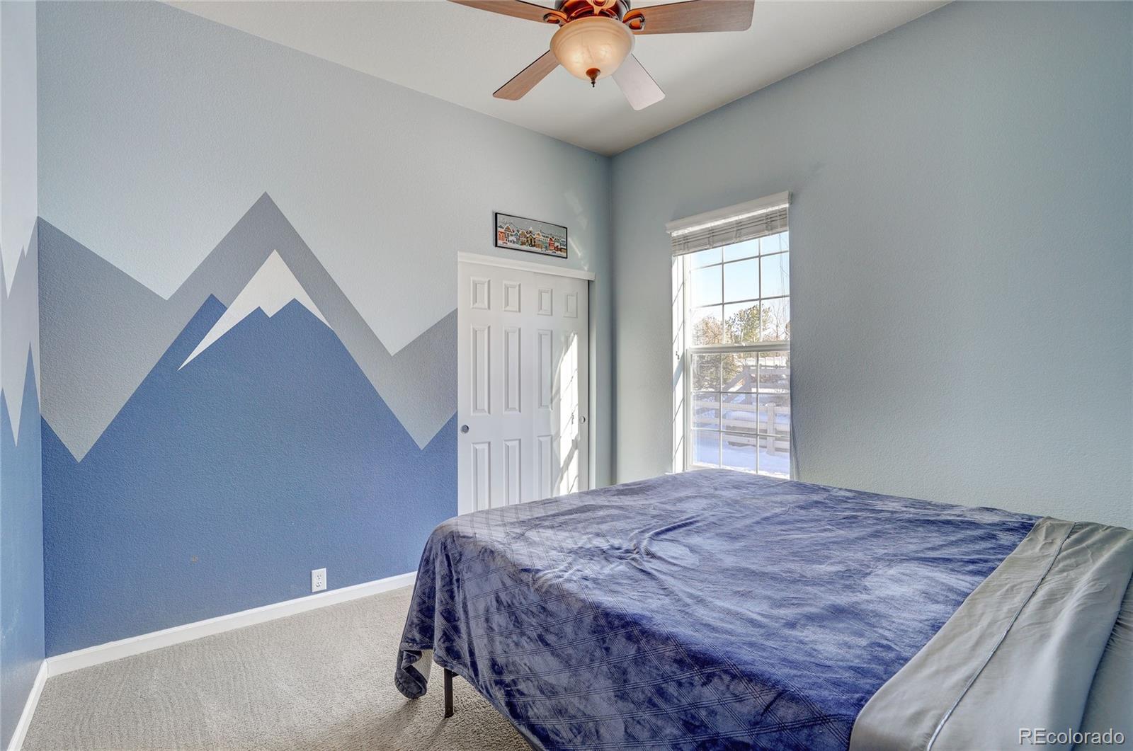 3563 Vestal Loop Broomfield, CO 80023 - Photo 25 of 38 a bedroom with a bed and a ceiling fan