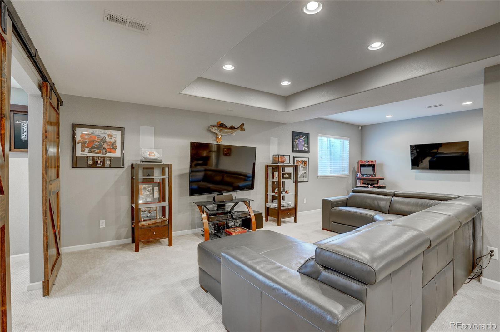 3563 Vestal Loop Broomfield, CO 80023 - Photo 27 of 38 a living room with furniture and a flat screen tv