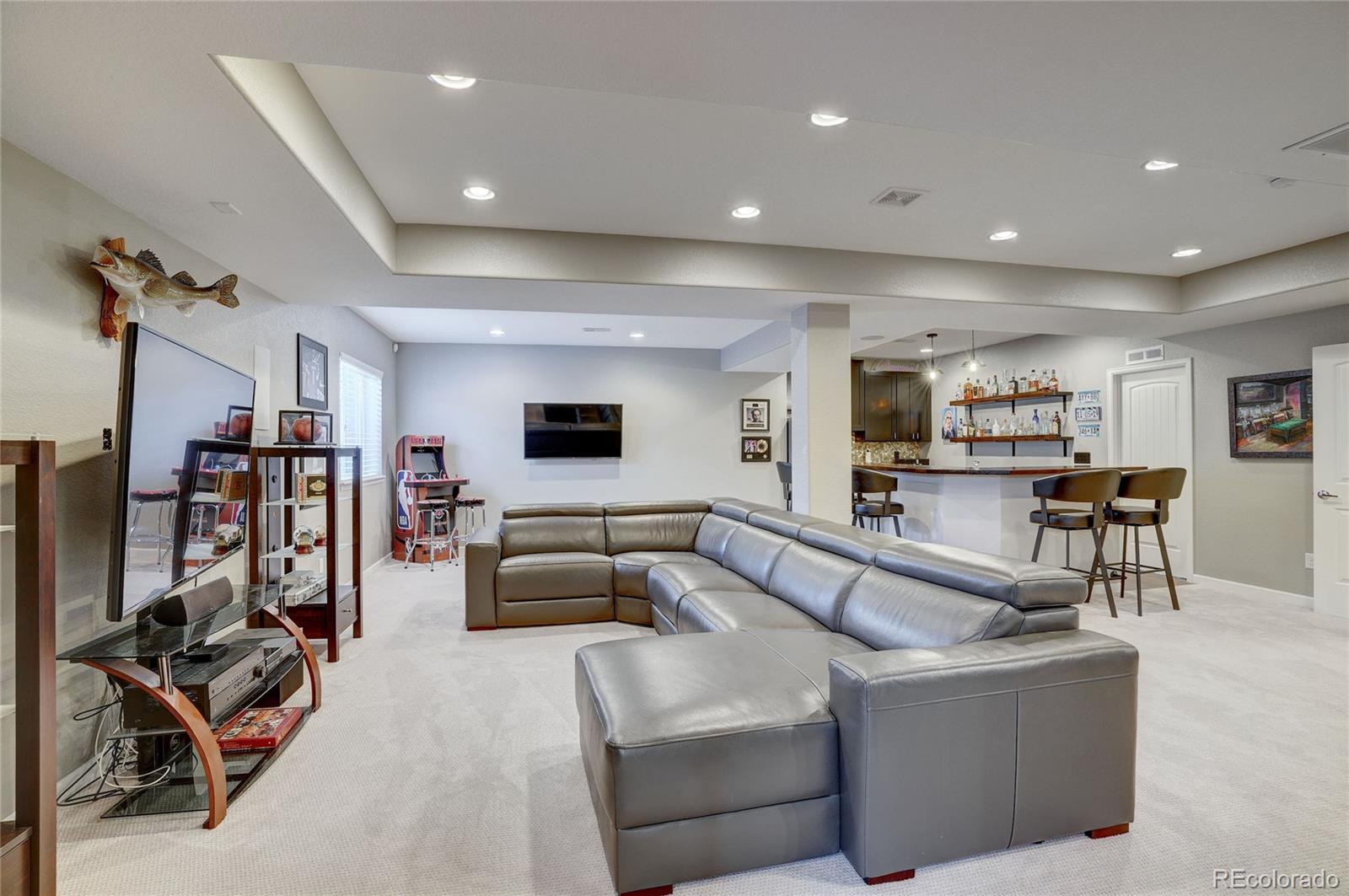 3563 Vestal Loop Broomfield, CO 80023 - Photo 28 of 38 a living room with furniture and a flat screen tv