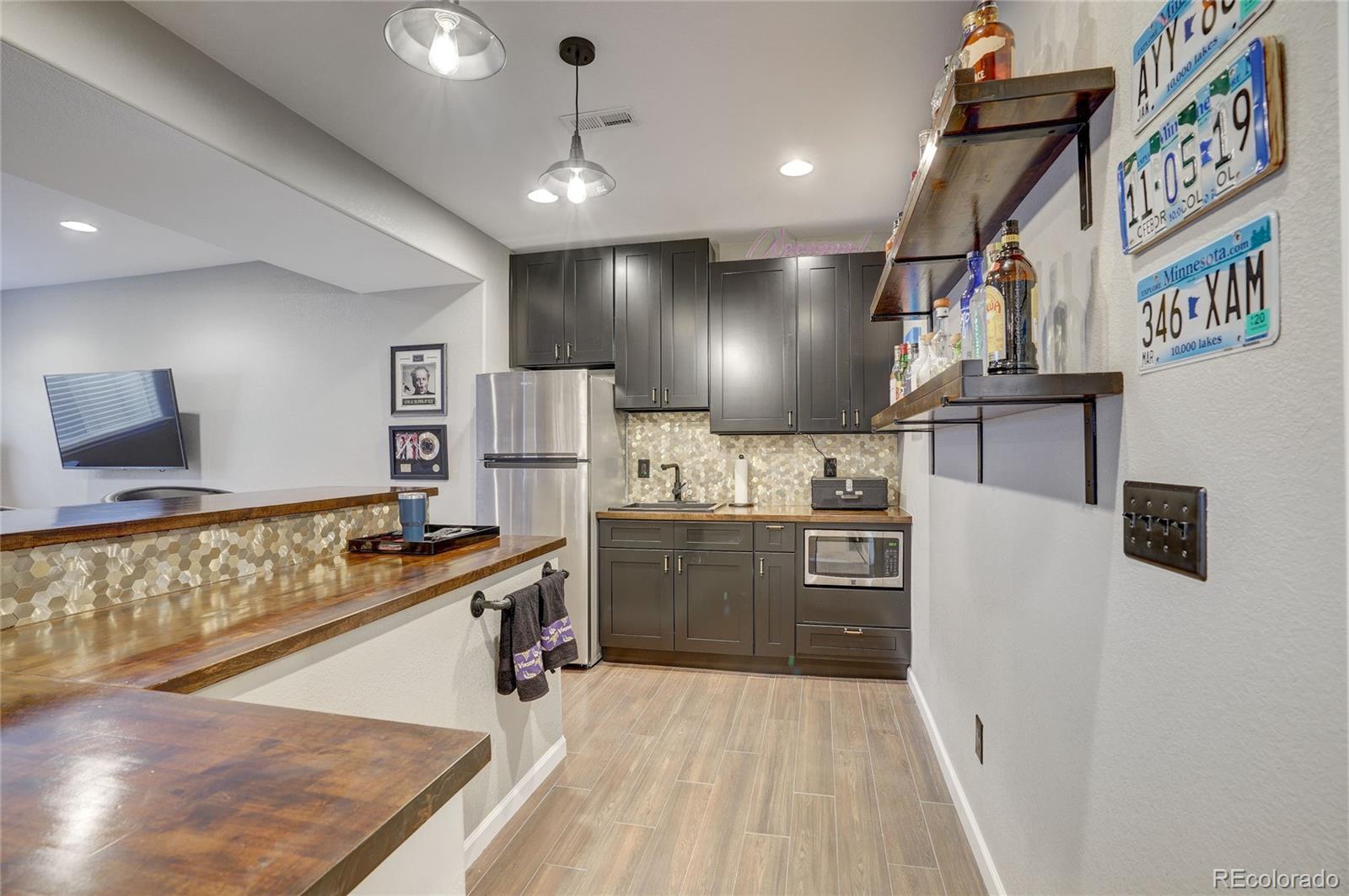 3563 Vestal Loop Broomfield, CO 80023 - Photo 30 of 38 a kitchen with stainless steel appliances granite countertop a sink and stove top oven