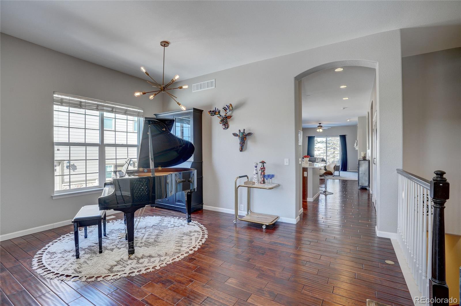 3563 Vestal Loop Broomfield, CO 80023 - Photo 3 of 38 a living room with furniture and a wooden floor