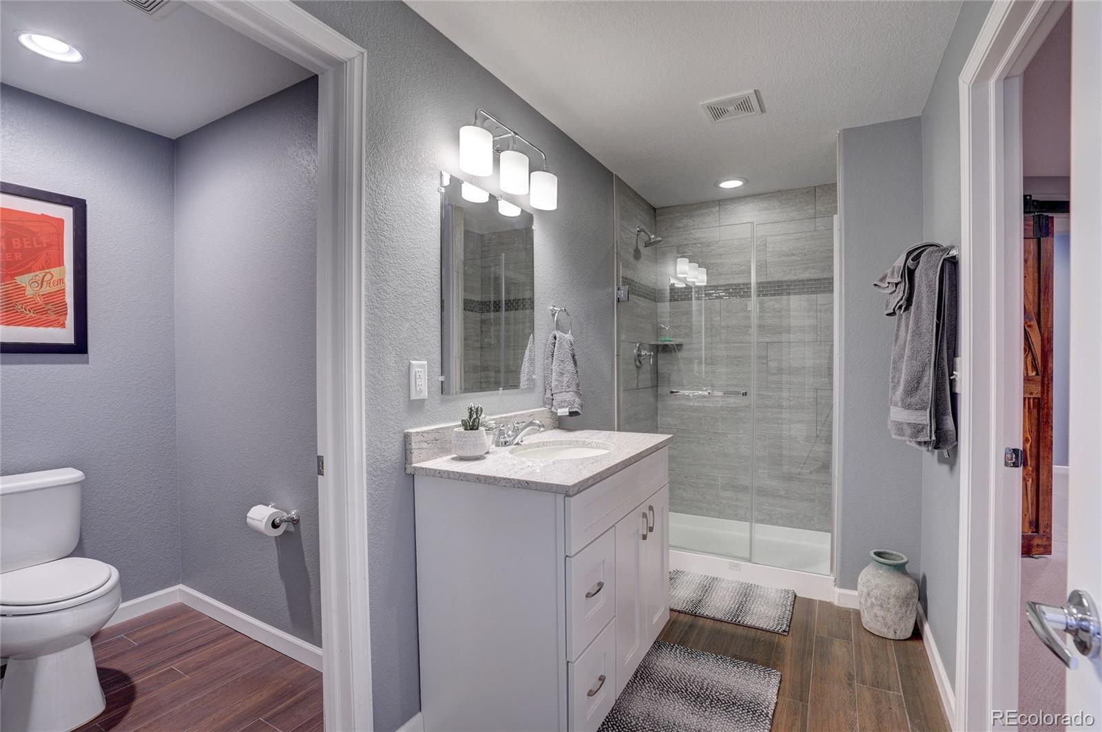 3563 Vestal Loop Broomfield, CO 80023 - Photo 32 of 38 a bathroom with a sink a toilet and shower