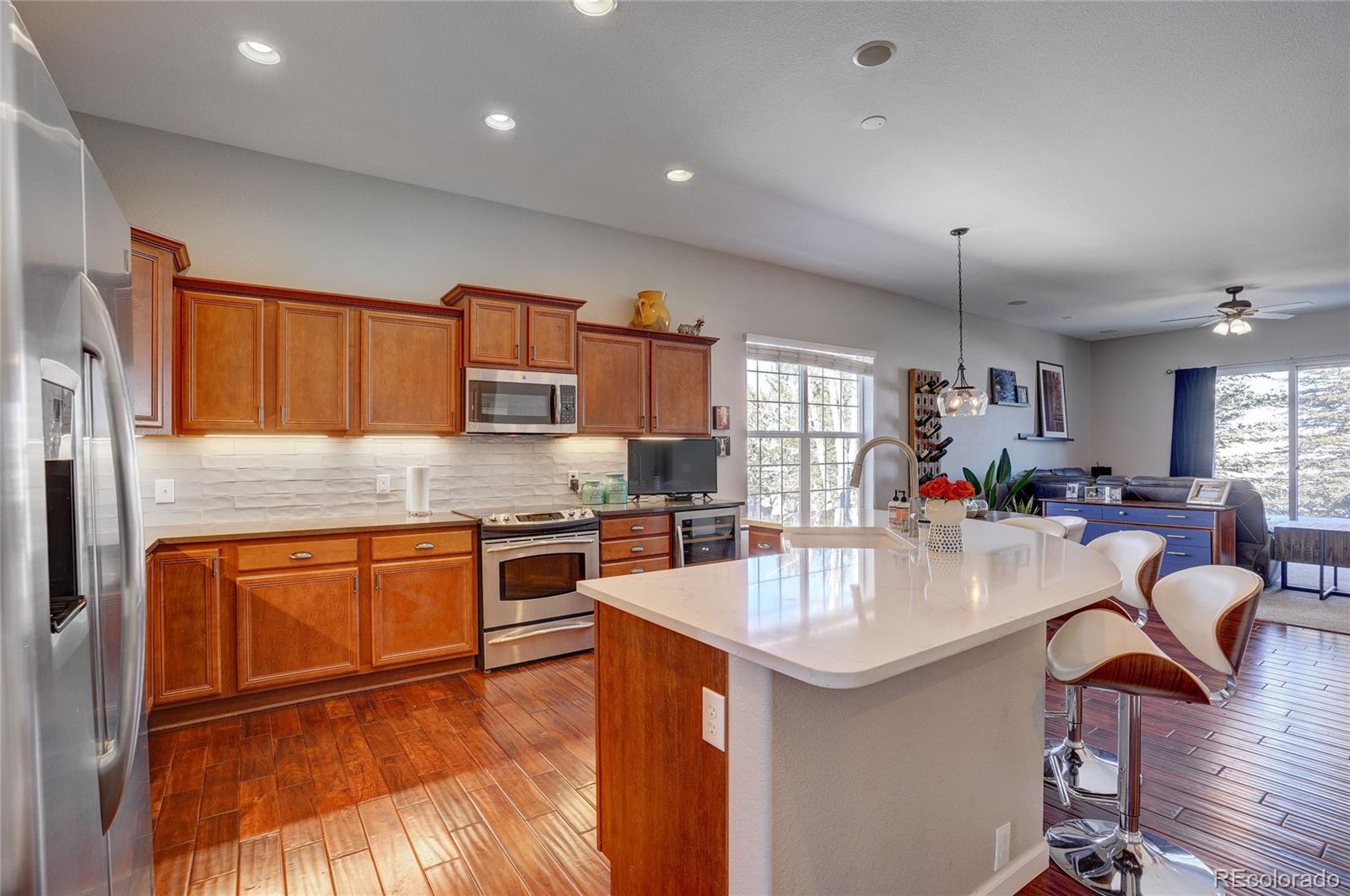 3563 Vestal Loop Broomfield, CO 80023 - Photo 7 of 38 a kitchen with stainless steel appliances granite countertop a sink stove and refrigerator