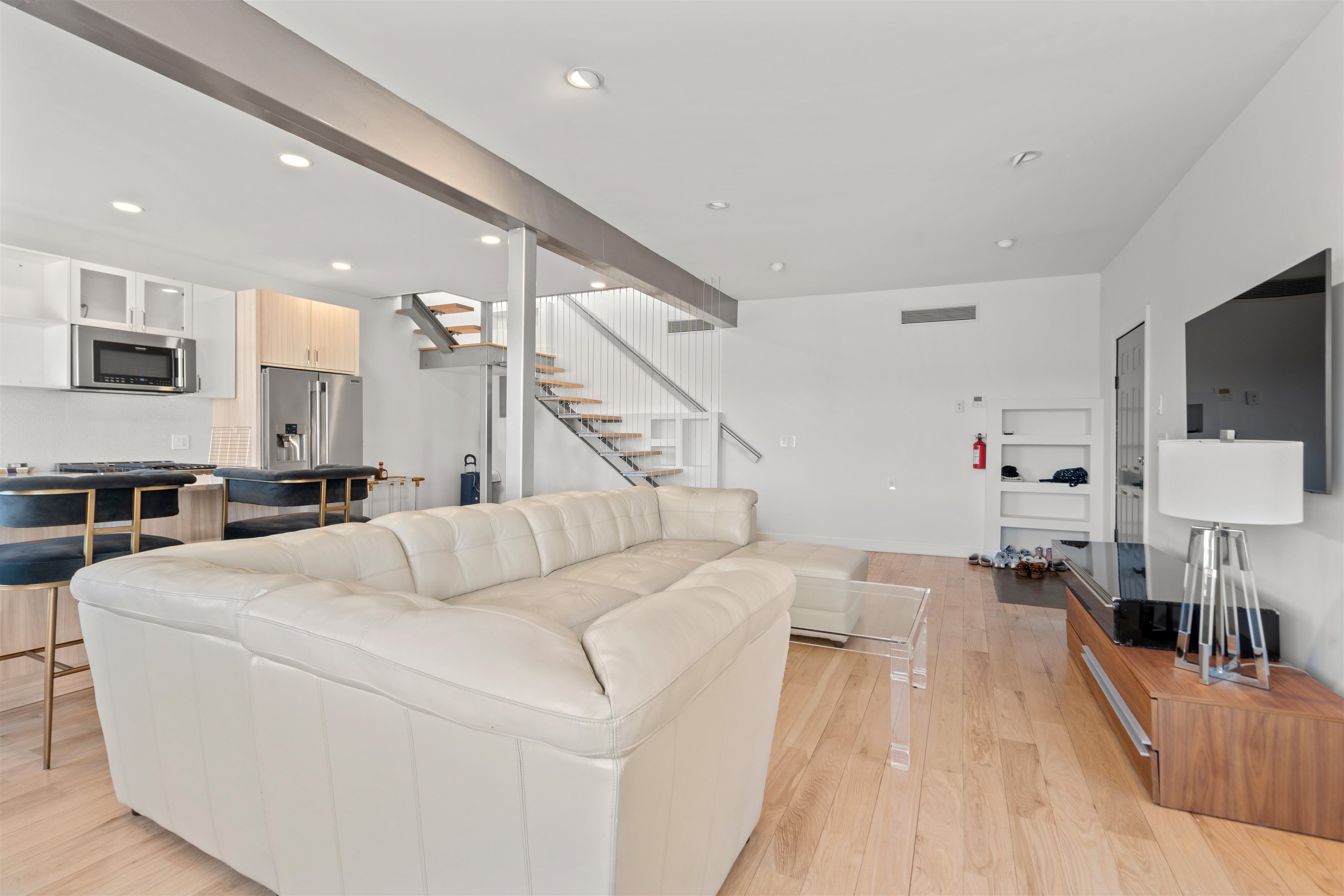 9009 Riverside Place, Unit 3 North Bergen, NJ 07047 - Photo 11 of 18 a living room with furniture and a flat screen tv