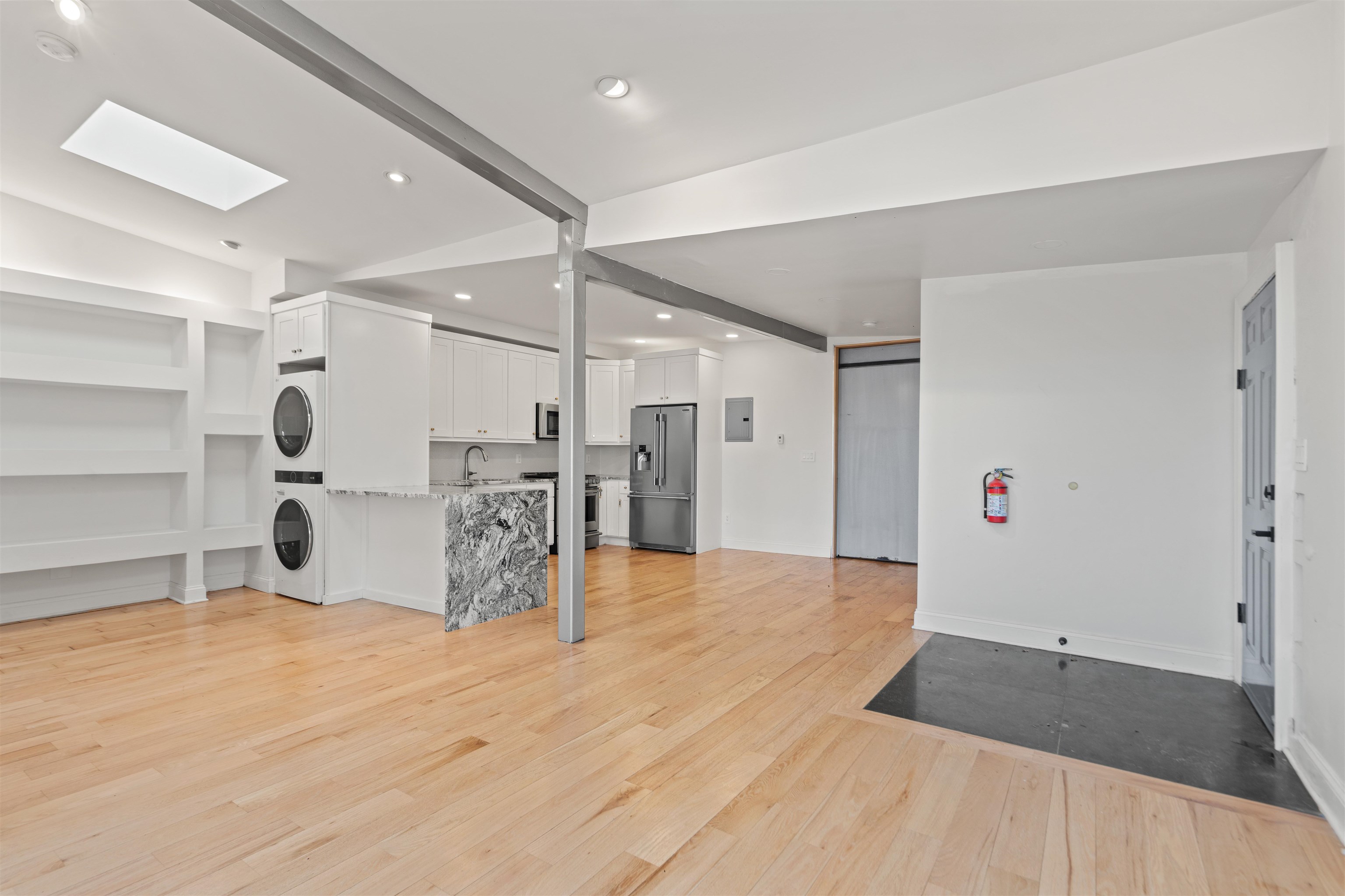 9009 Riverside Place, Unit 3 North Bergen, NJ 07047 - Photo 4 of 18 a large room with a cabinet and mirrors