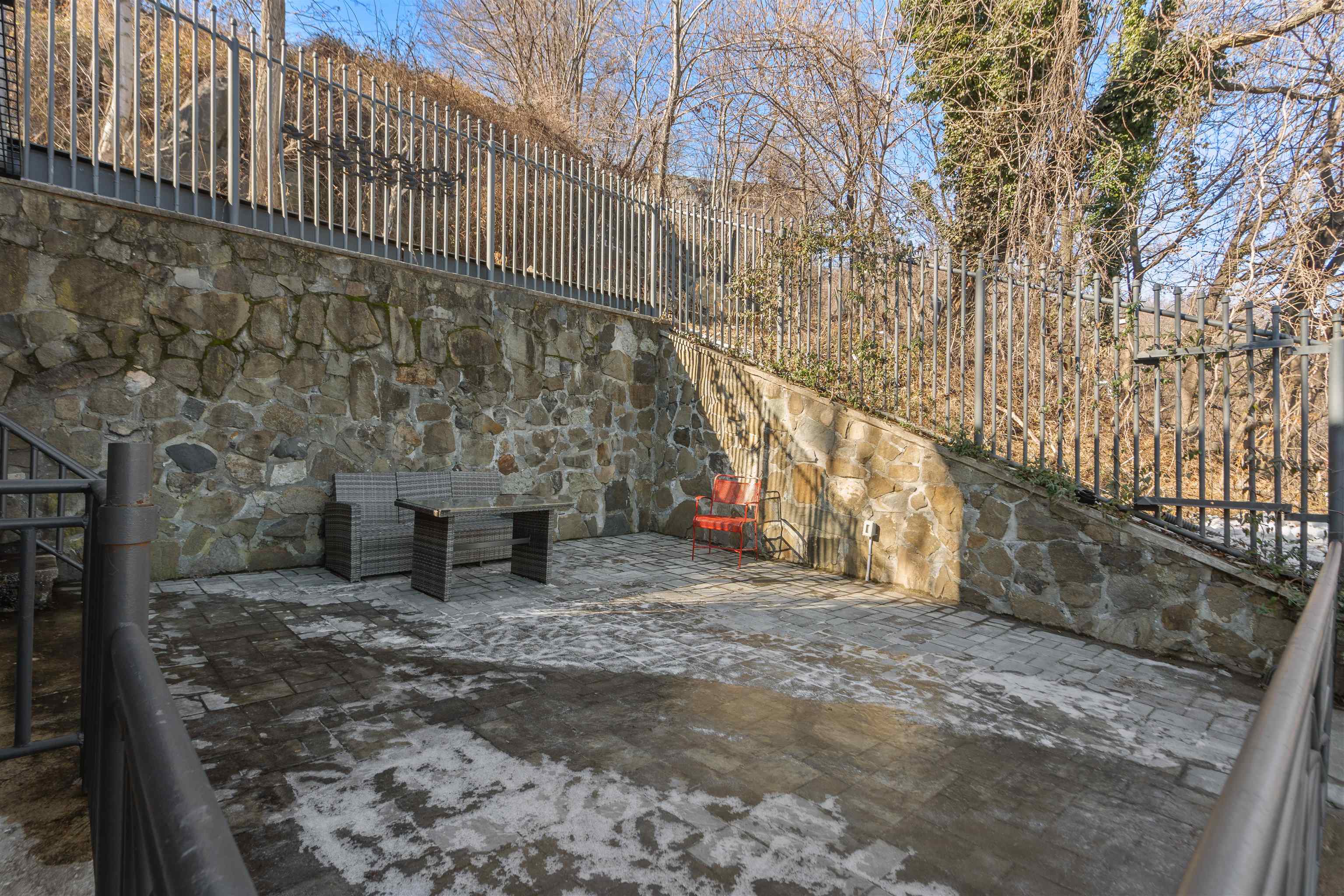 9009 Riverside Place, Unit 3 North Bergen, NJ 07047 - Photo 5 of 18 a backyard of a building with large trees and wooden fence