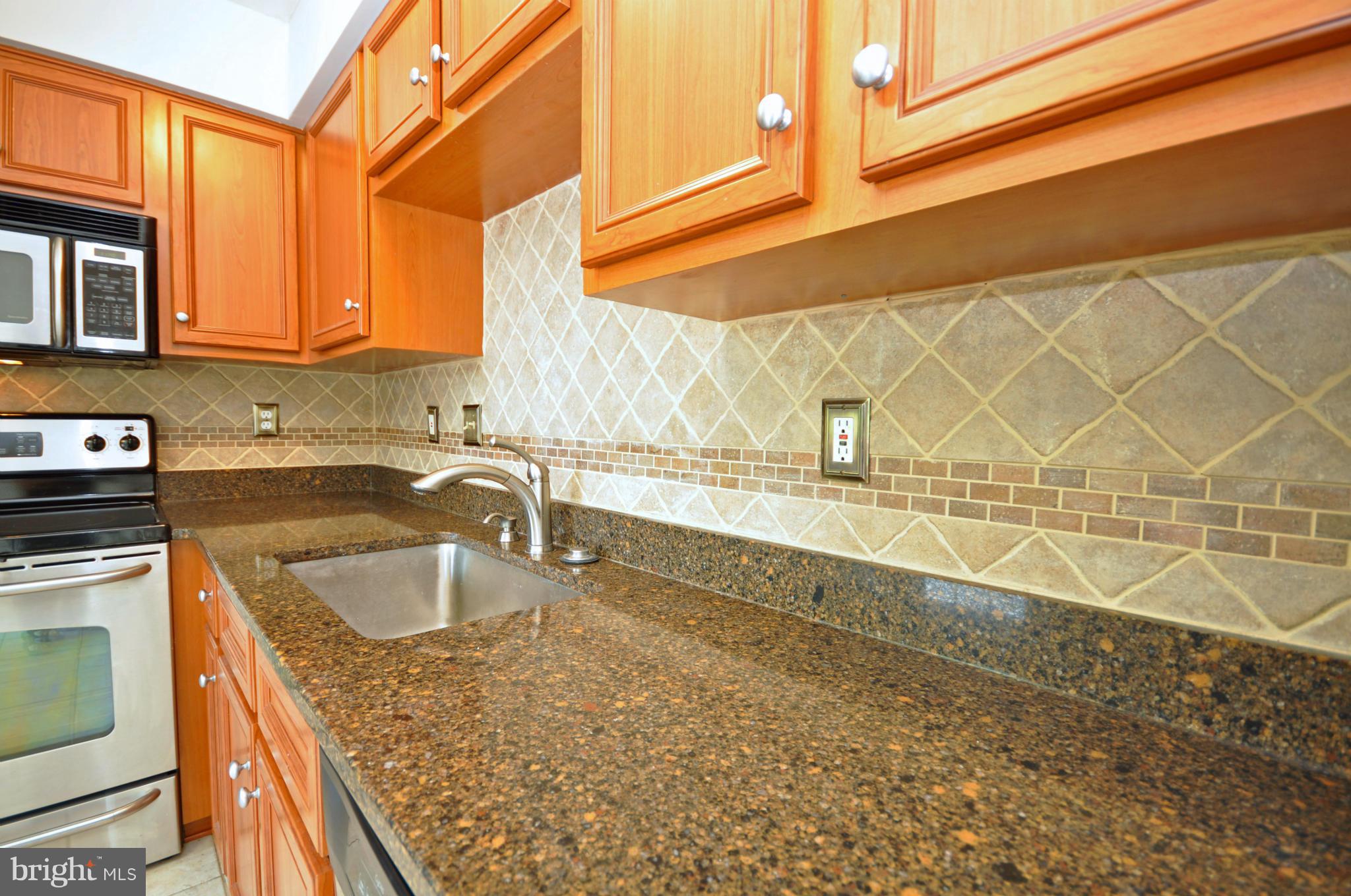 5413 Canonbury Road Baltimore, MD 21237 - Photo 11 of 30 Granite Counters and Tiled Backsplash