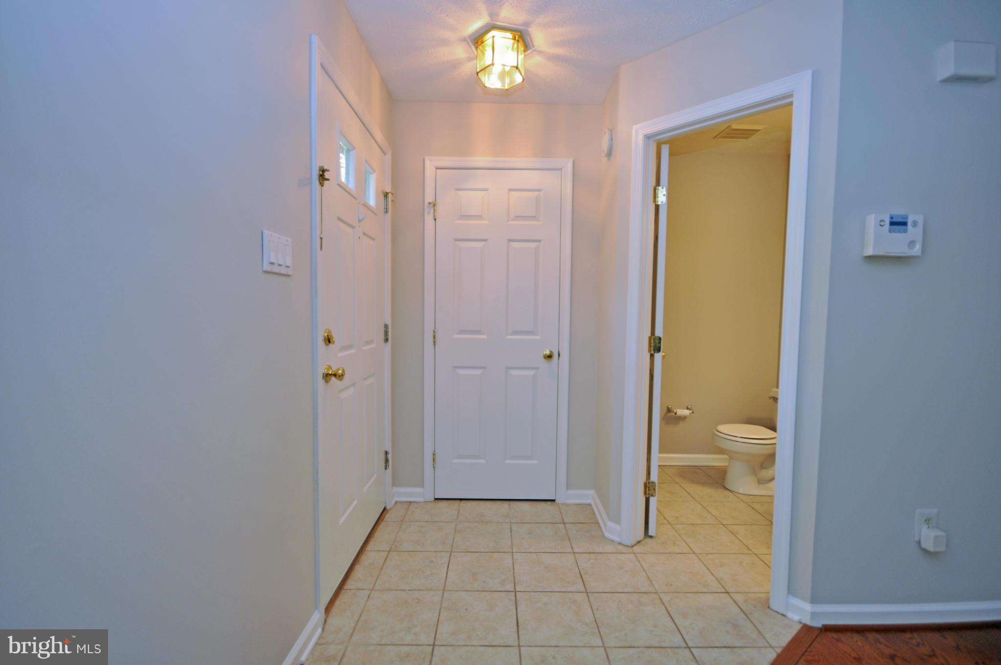 5413 Canonbury Road Baltimore, MD 21237 - Photo 4 of 30 Tiled Entry with Coat Closet and Powder Room