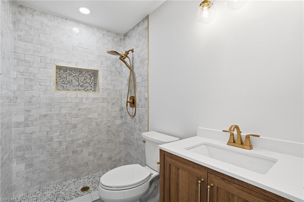 8336 Lagoon Road Fort Myers Beach, FL 33931 - Photo 17 of 50 The bathroom features a walk-in shower with light-toned subway tiling and a mosaic-tiled niche - Virtually Edited Image
