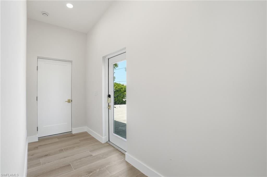 8336 Lagoon Road Fort Myers Beach, FL 33931 - Photo 2 of 50 Entryway with light-colored tile flooring, white walls, and a recessed ceiling light - Virtually Edited Image