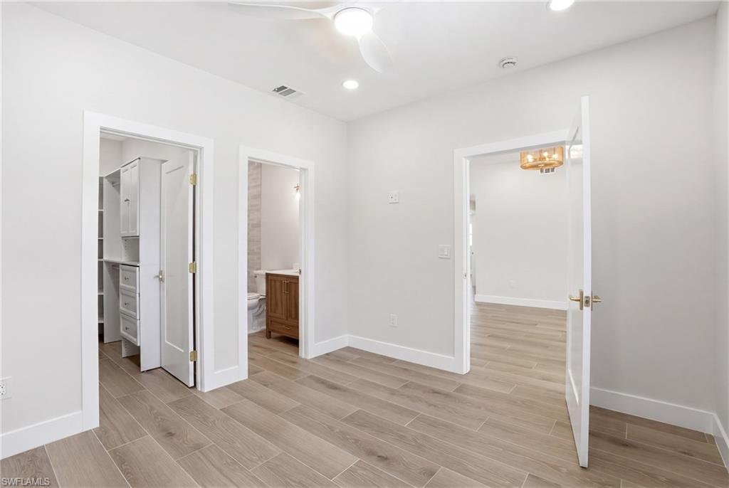 8336 Lagoon Road Fort Myers Beach, FL 33931 - Photo 21 of 50 This room features light-colored tile flooring, a ceiling fan with integrated lighting, and recessed ceiling lights - Virtually Edited Image