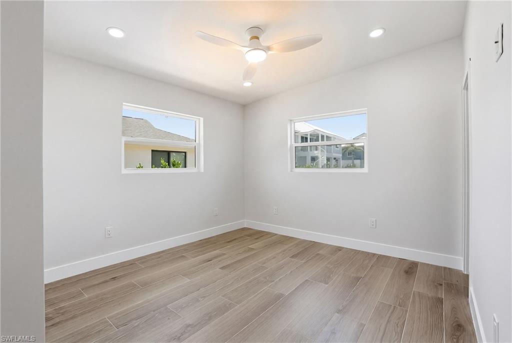 8336 Lagoon Road Fort Myers Beach, FL 33931 - Photo 25 of 50 This room features sleek flooring, recessed lighting, and a ceiling fan - Virtually Edited Image