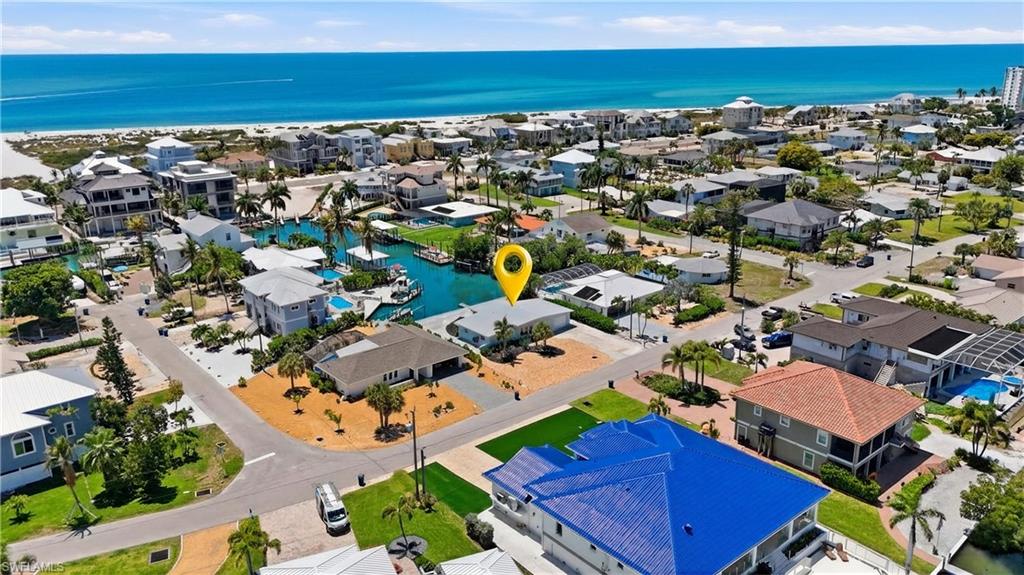 8336 Lagoon Road Fort Myers Beach, FL 33931 - Photo 31 of 50 Aerial view showcasing the property's location within a coastal community, featuring nearby waterways and proximity to the beach with ocean views - Virtually Edited Image
