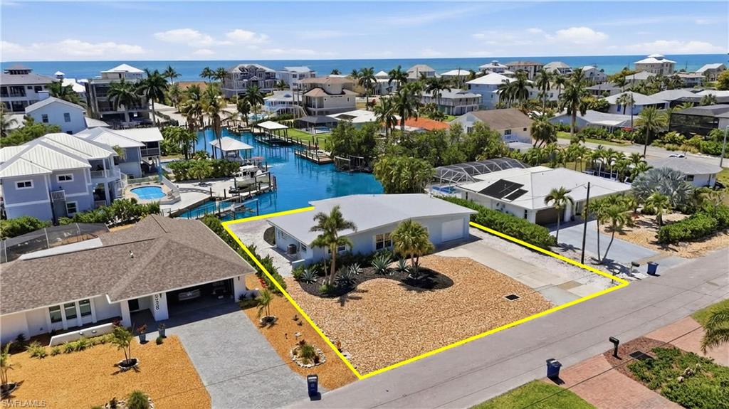 8336 Lagoon Road Fort Myers Beach, FL 33931 - Photo 32 of 50 Aerial view showcasing the property's location within a coastal community, featuring nearby waterways and proximity to the beach with ocean views - Virtually Edited Image