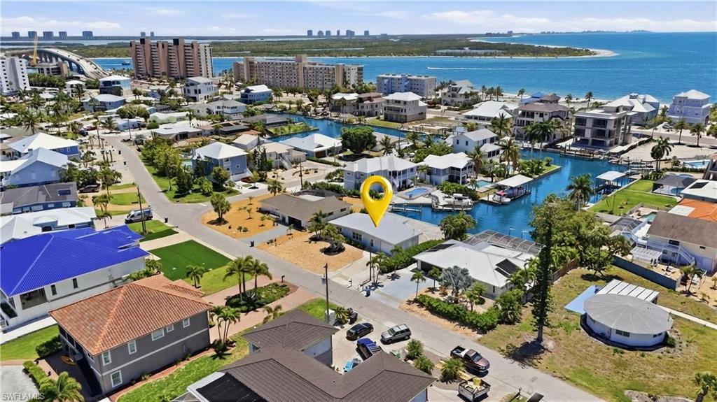 8336 Lagoon Road Fort Myers Beach, FL 33931 - Photo 33 of 50 Aerial view of the property and surrounding neighborhood, featuring water views, nearby buildings, and residential streets - Virtually Edited Image