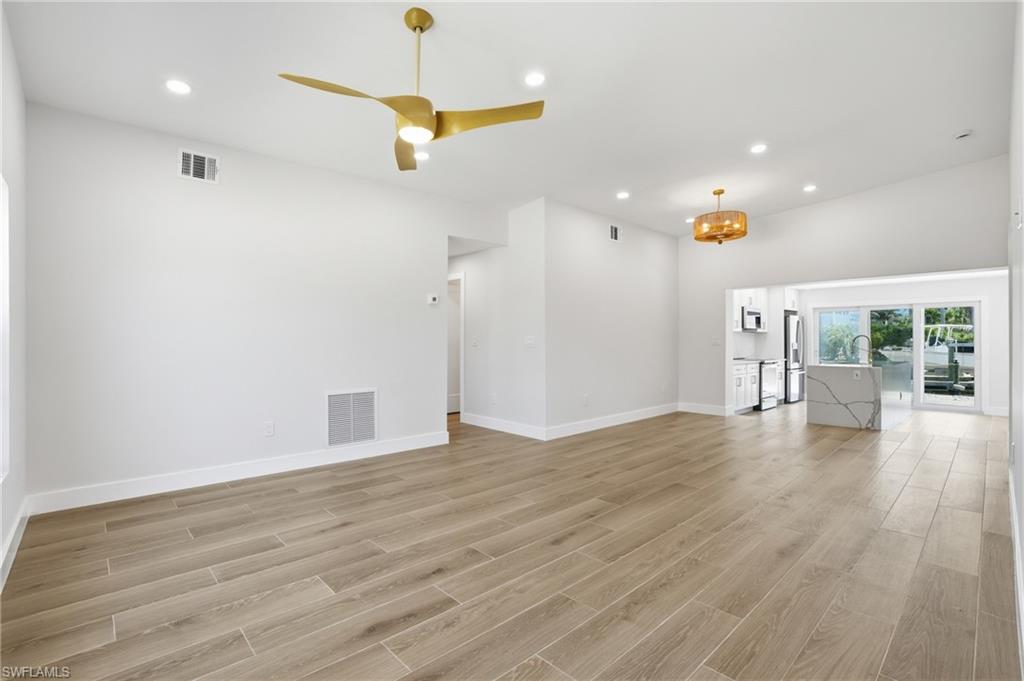 8336 Lagoon Road Fort Myers Beach, FL 33931 - Photo 4 of 50 Spacious interior featuring a contemporary ceiling fan, recessed lighting, and light-toned tile flooring - Virtually Edited Image