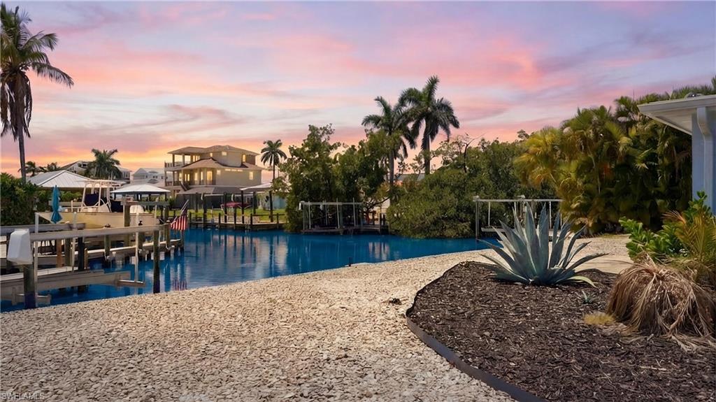 8336 Lagoon Road Fort Myers Beach, FL 33931 - Photo 46 of 50 The property features a waterfront location with a private dock - Virtually Edited Image