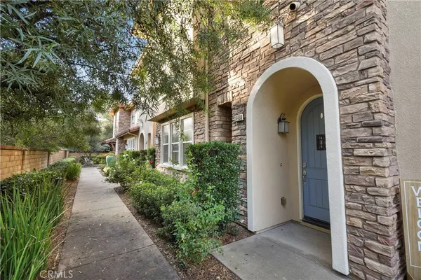 a front view of a house with plants
