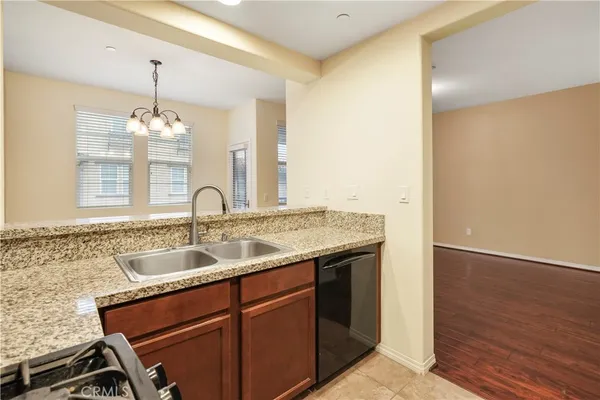 a bathroom with a granite countertop sink a toilet and a mirror