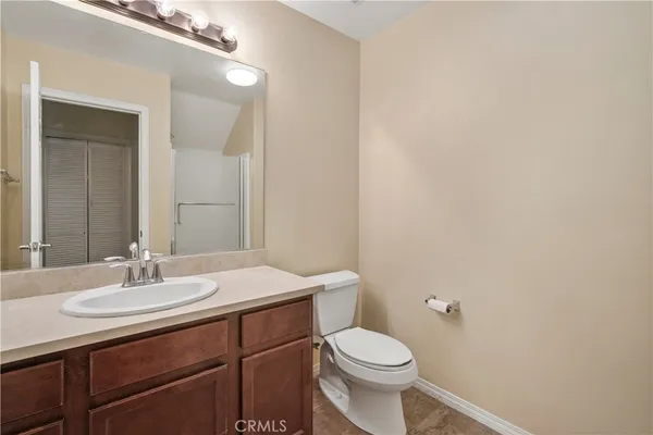 a bathroom with a sink a toilet and mirror